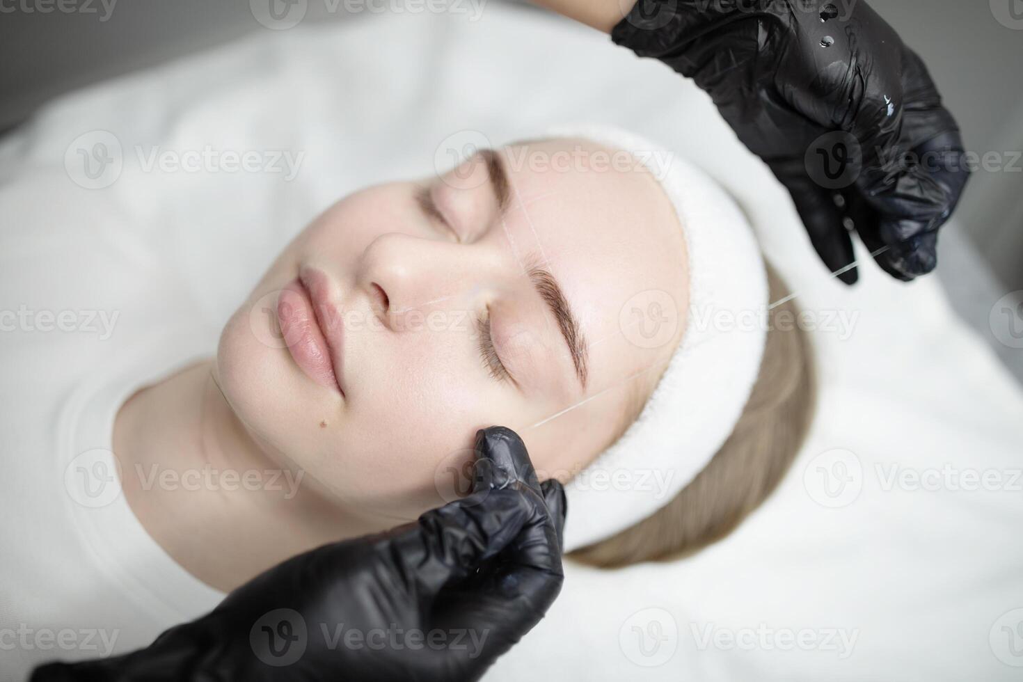 Ladies indulge in a pampering session, receiving permanent makeup procedures in a serene salon environment. The focus is on enhancing their beauty with skilled techniques. photo