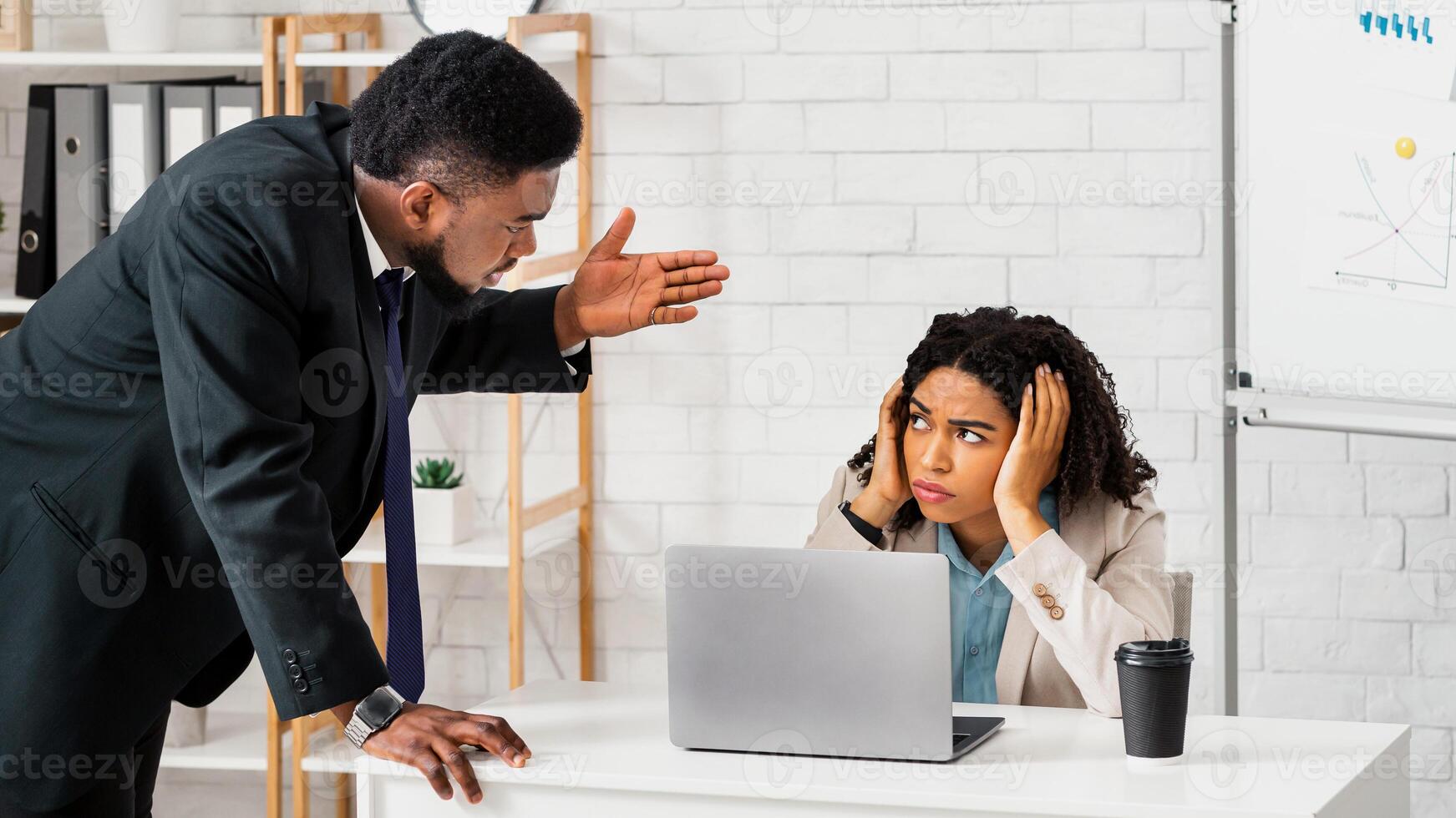 Displeased male boss scolding upset female employee for mistake in company project or missed deadline at modern office. Workplace challenges and difficulties concept photo