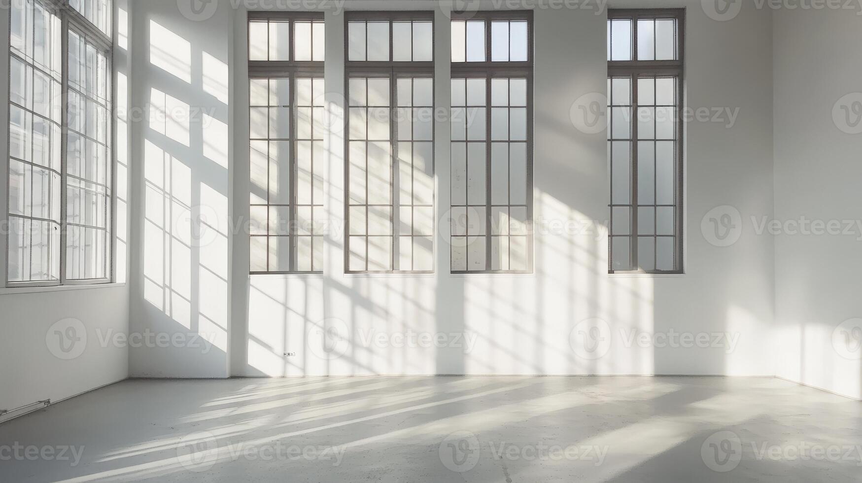 Bright sunlit room with large windows casting shadows on white walls photo