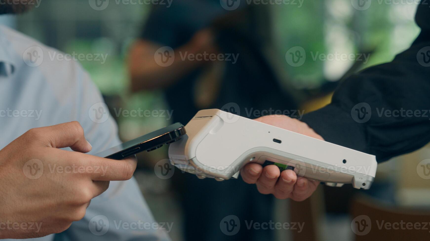 Close up hands visitor man pay bill food order in cafe restaurant unrecognizable waiter holding terminal wifi scan using smartphone contactless NFC payment cashless client service mobile phone bank photo