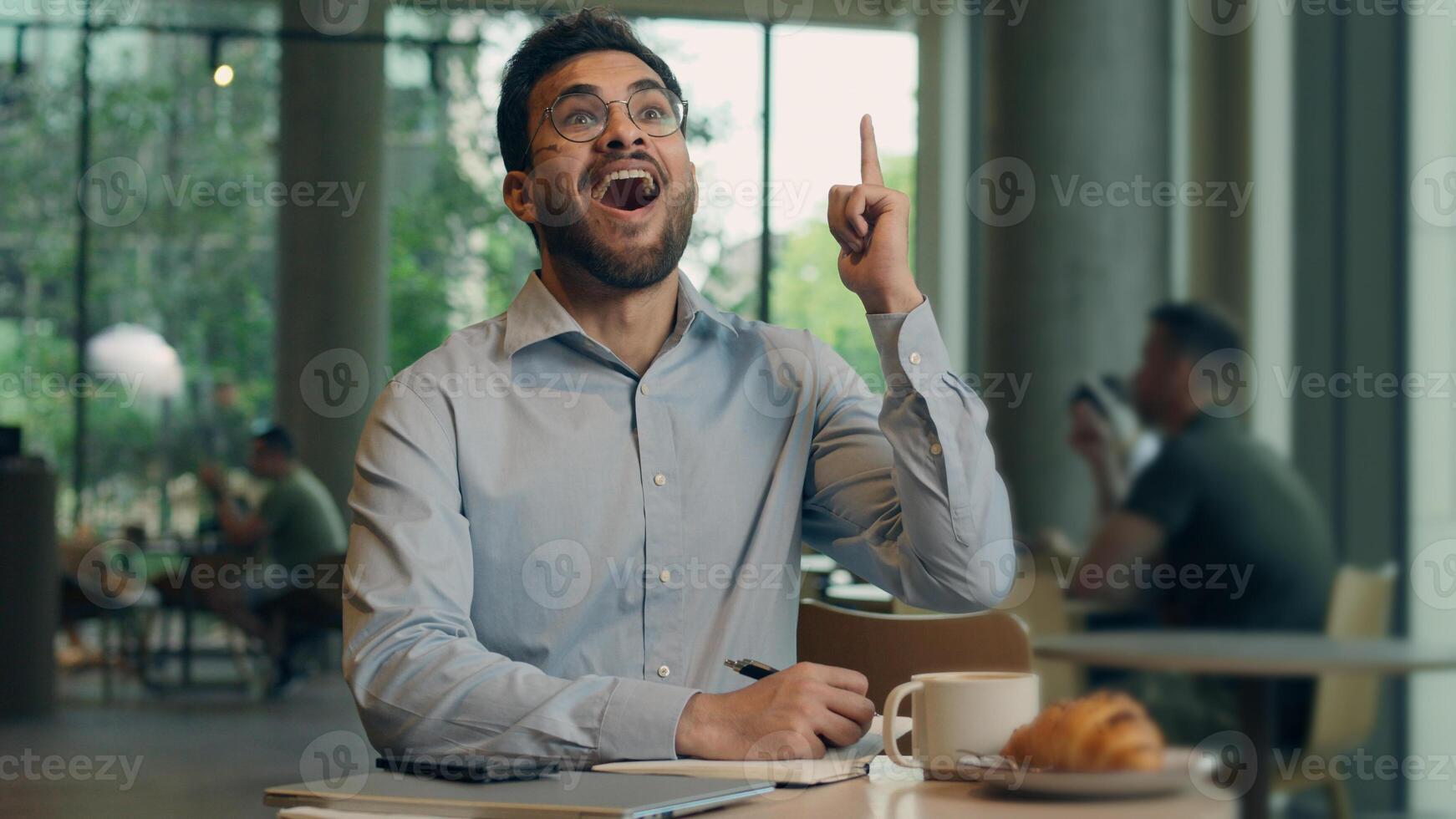 Pensive man Indian Arabian businessman male freelancer worker thoughtful student think plan create study write notebook in cafe pondering business guy inspiration come up with idea insight happy smile photo