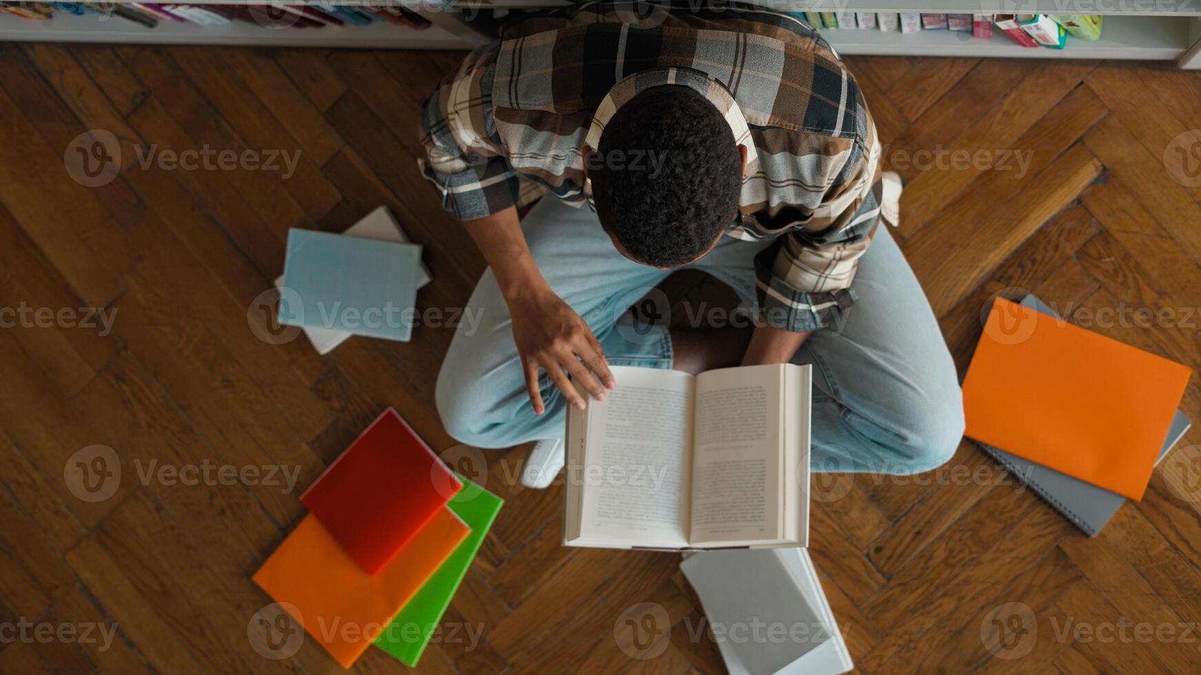 Top view African American man male guy unrecognizable student library bookshop bookshelf read pile books textbooks high school bookworm librarian study exam knowledge research educate learner pupil photo