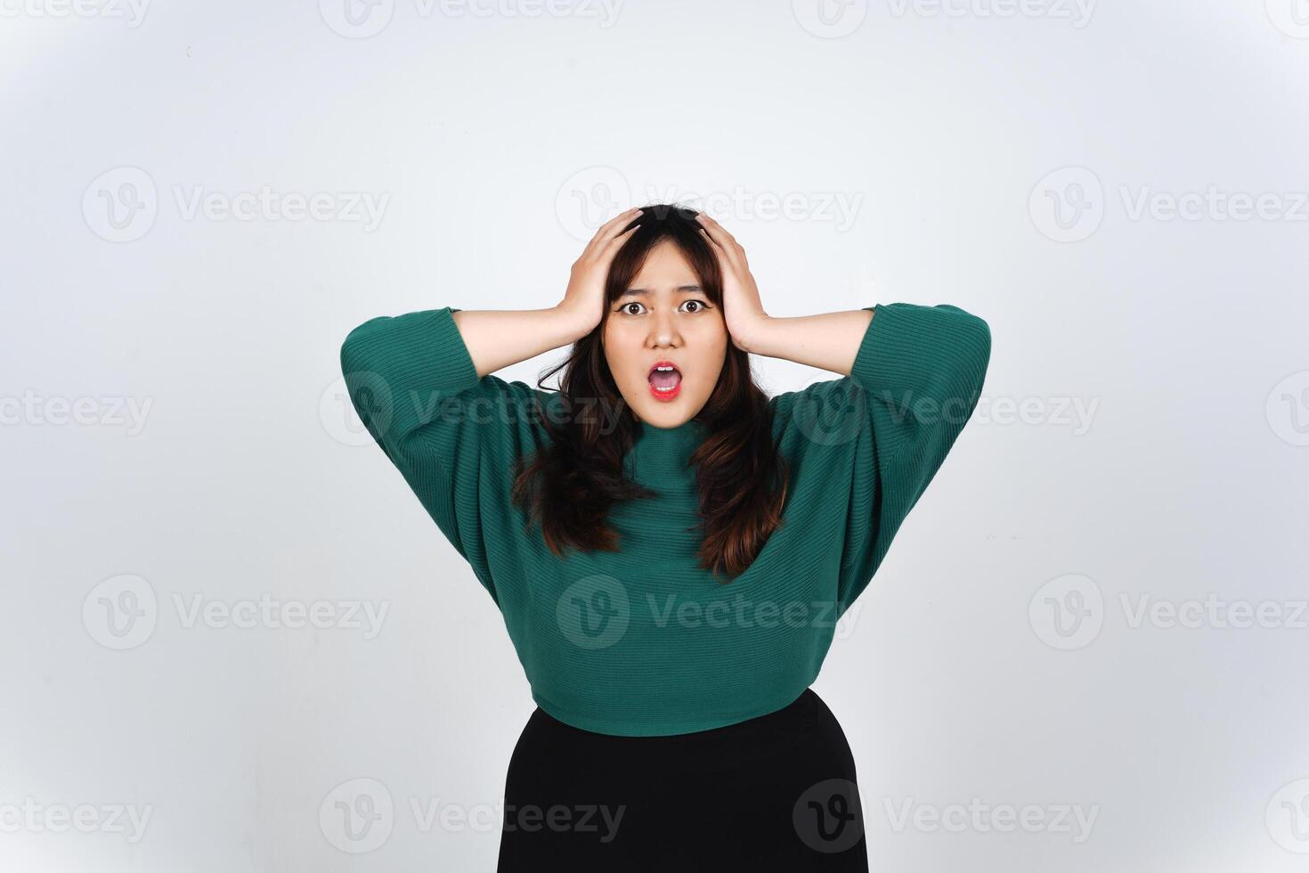 Hand on Head with shocked wow face expression Of Beautiful Asian Woman wearing Green Isolated On White Background photo