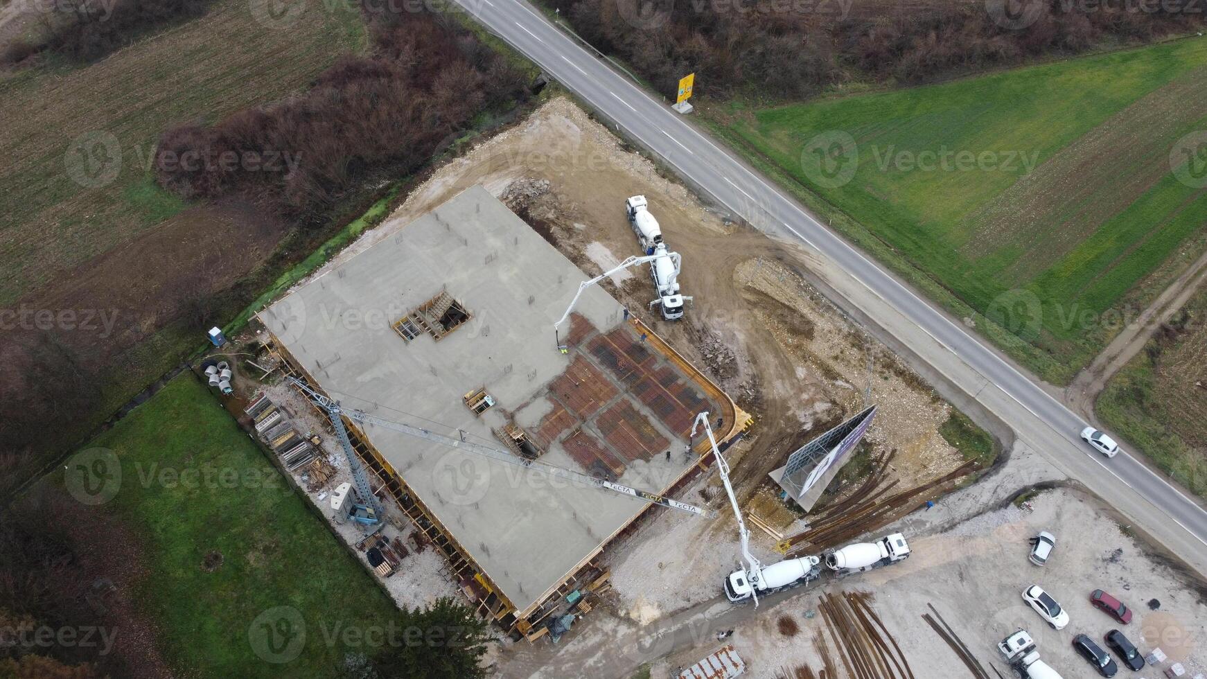 An aerial view captured by a drone showcasing the ongoing construction of a modern building, highlighting the work on the structure, scaffolding, and machinery on site photo