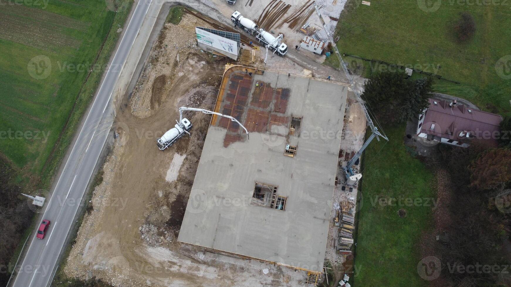 An aerial view captured by a drone showcasing the ongoing construction of a modern building, highlighting the work on the structure, scaffolding, and machinery on site photo