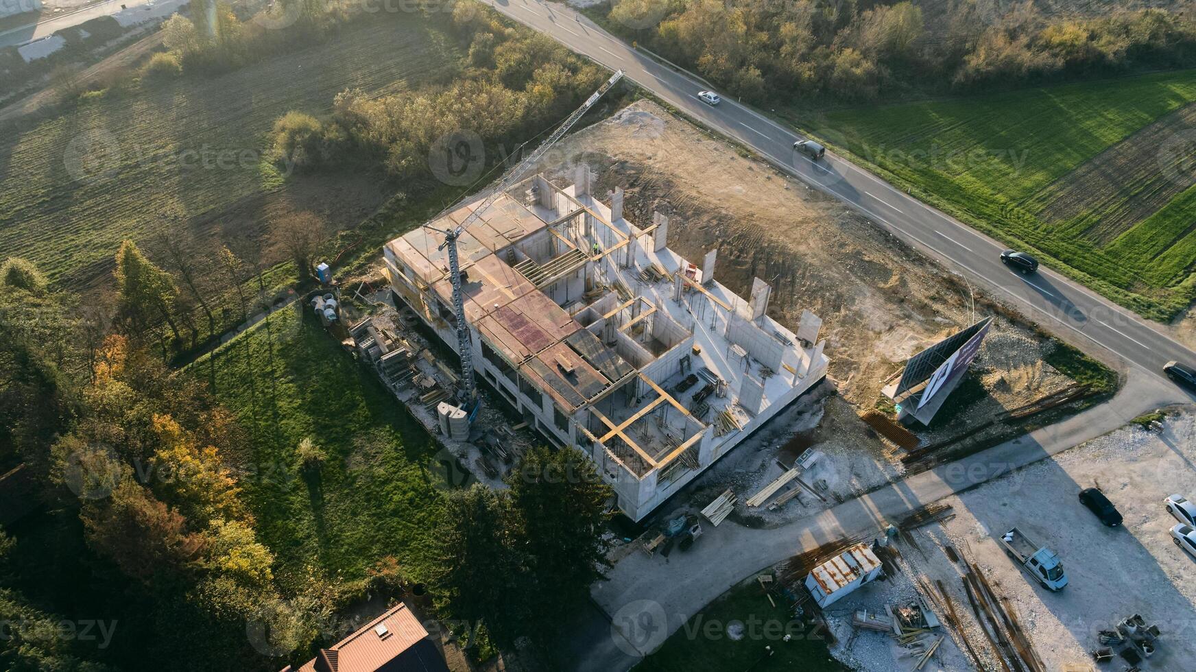 An aerial view captured by a drone showcasing the ongoing construction of a modern building, highlighting the work on the structure, scaffolding, and machinery on site photo