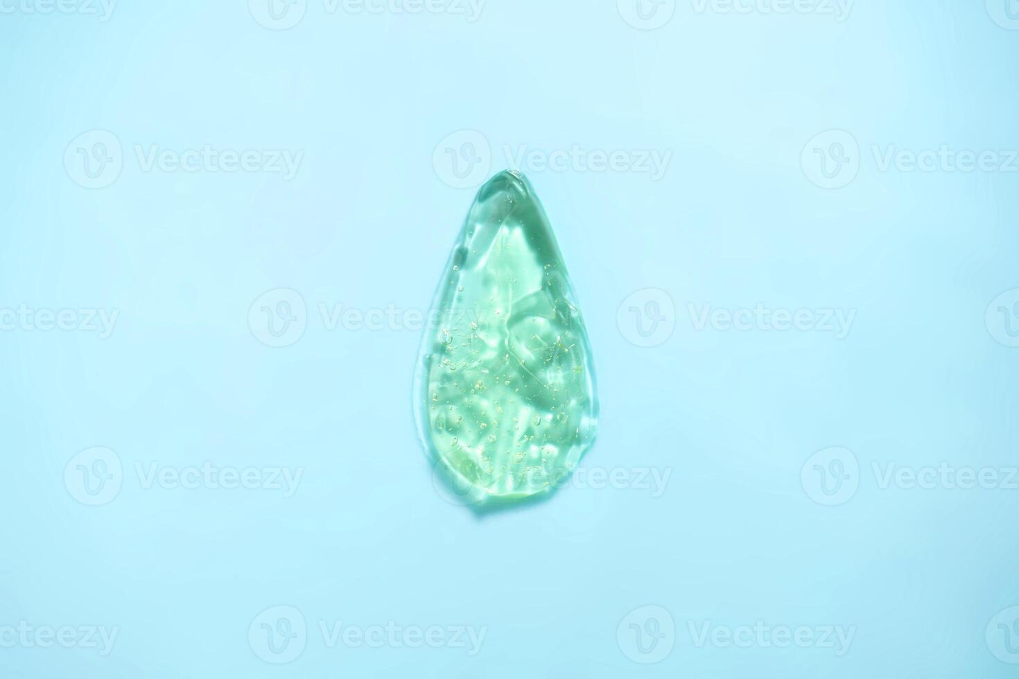 Drop shaped gel on blue background photo