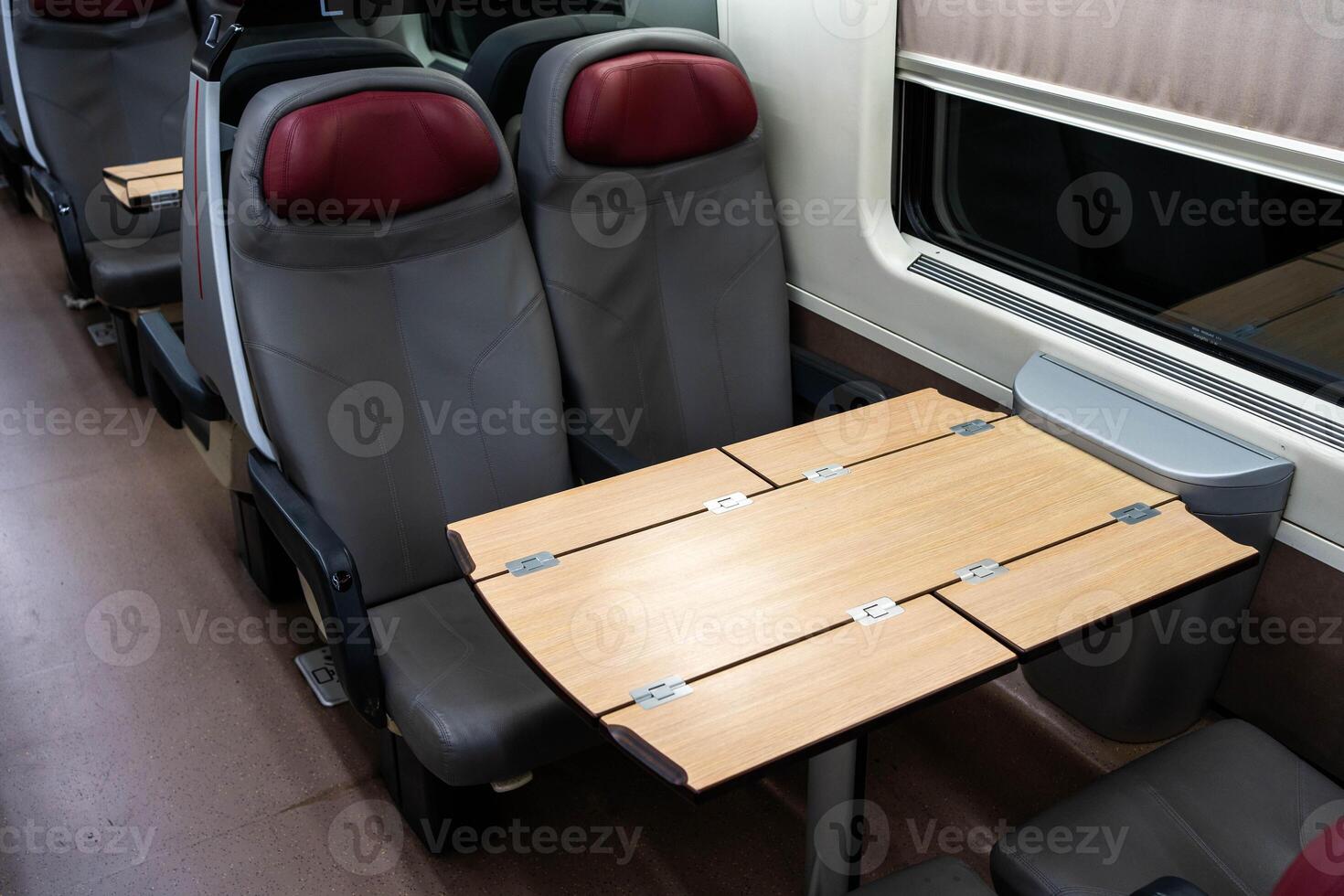 Empty seats and a table in a passenger carriage photo