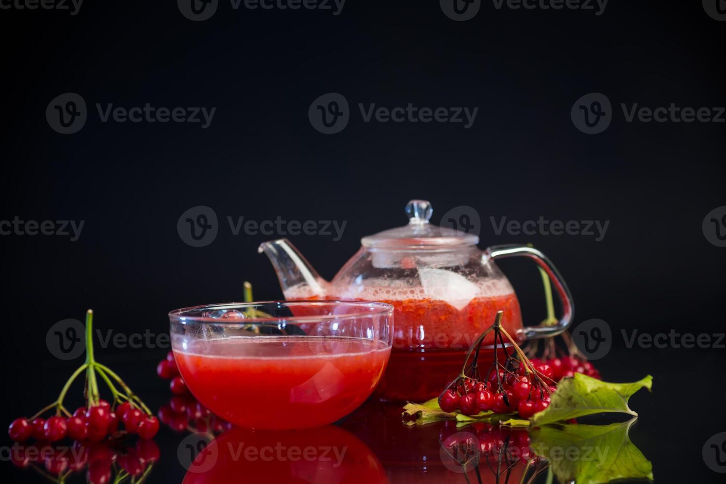 nutritious vitamin tea from viburnum berries, isolated on black background photo
