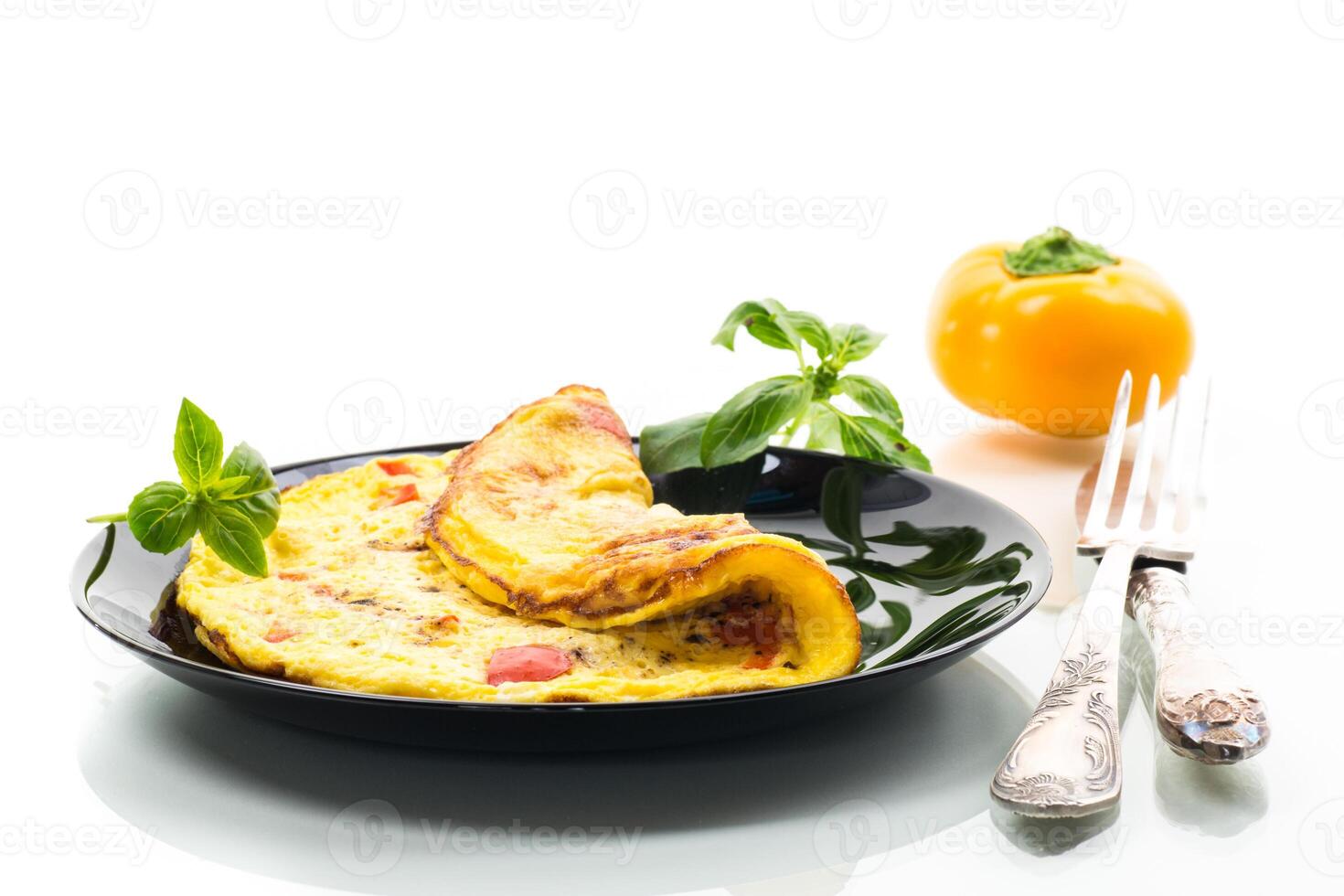 fried omelette with sweet pepper and vegetables in a plate, isolated on white background photo