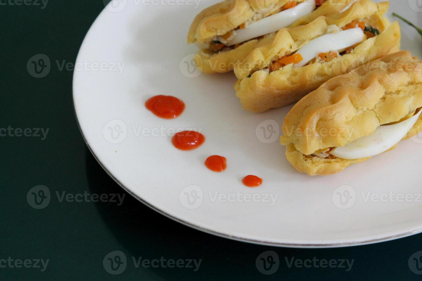 Fried Pastel with Egg Filling and Red Chili Garnish Close Up View on Plate Indonesian Snack Asian Cuisine photo