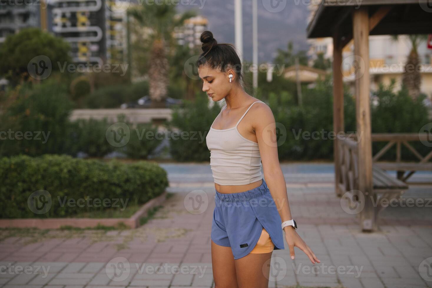 A Young Woman Engaging in Outdoor Exercise While Dressed in Comfortable Activewear photo
