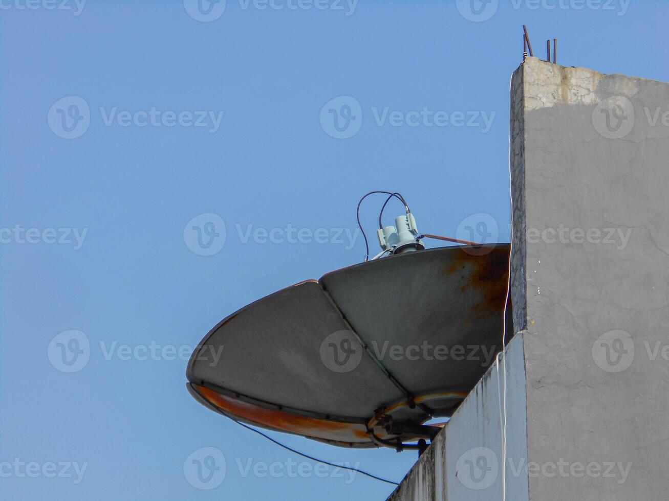 A satellite dish on top of a building photo