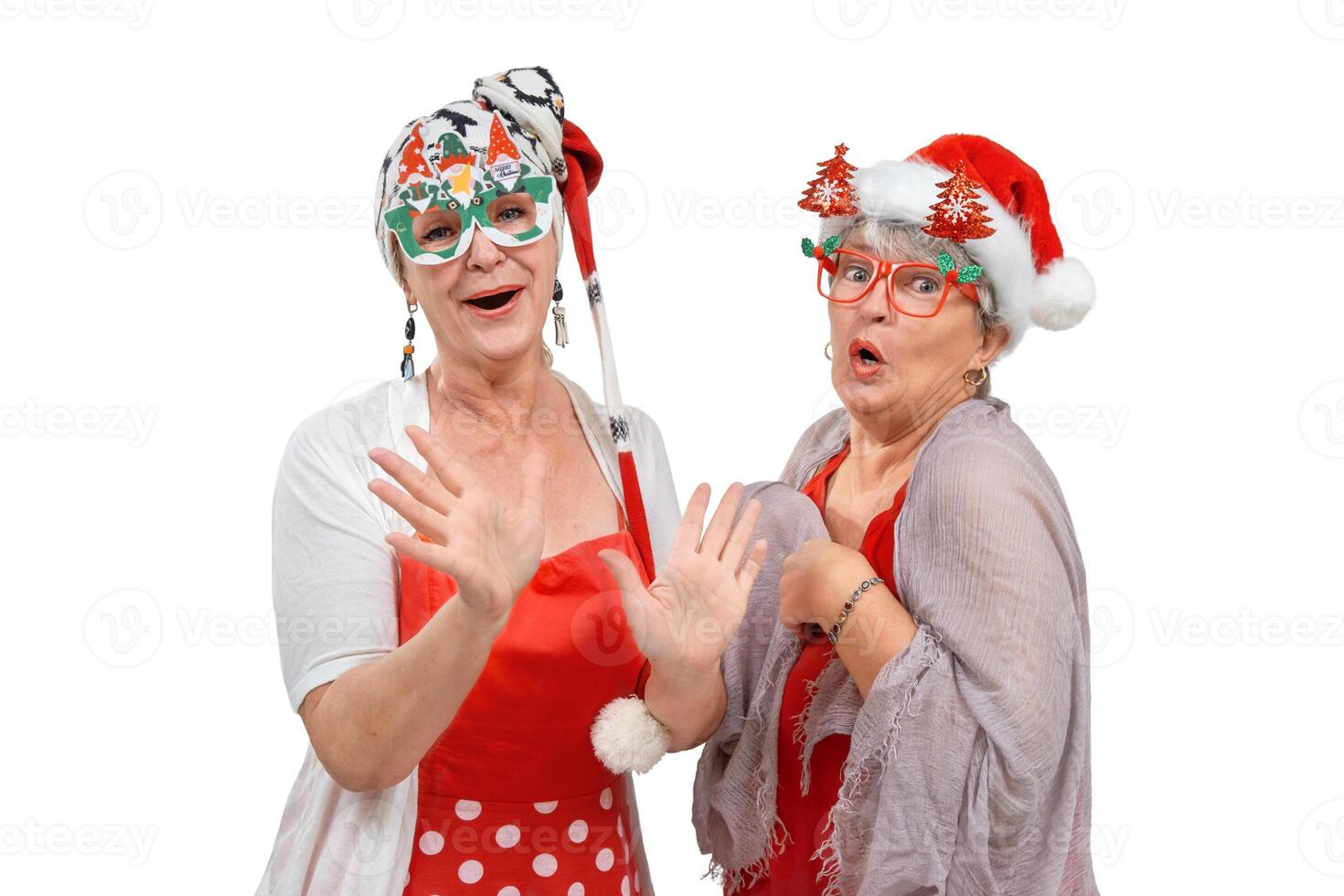 Two senior friends in Christmas outfits grimacing isolated photo