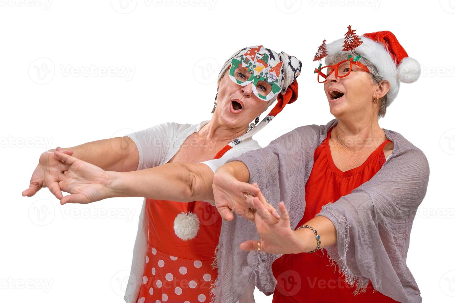 Two senior friends in christmas outfits singing together isolated photo