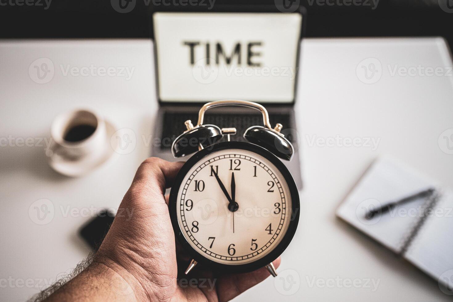 Business working time concept, word time on the laptop screen, notes and a clock on a office desk, stress at work, clock with five minutes to twelve o'clock. photo