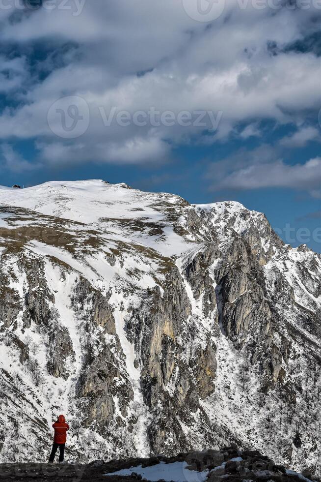The landscape view of a snowy mountain range. Winter background. photo