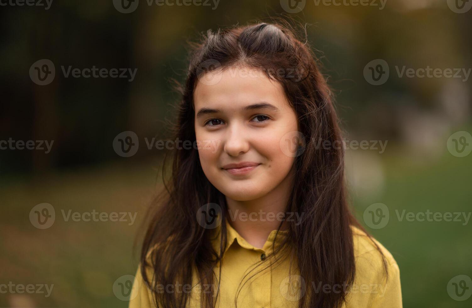 Portrait of a happy teenage girl looking at camera and smiling. photo