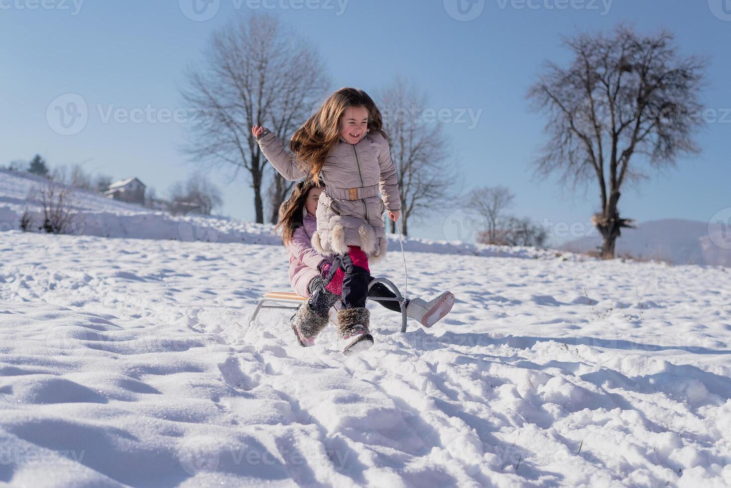 A happy children sled ride. Concept of a happy family winter holiday and playing in the snow. photo