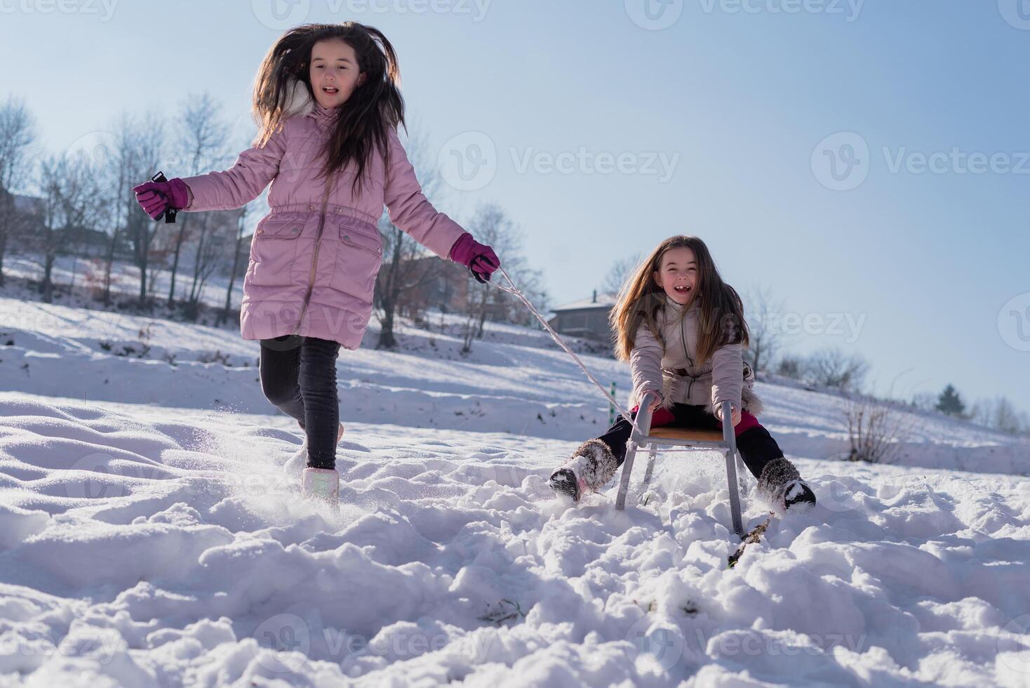A happy children sled ride. Concept of a happy family winter holiday and playing in the snow. photo
