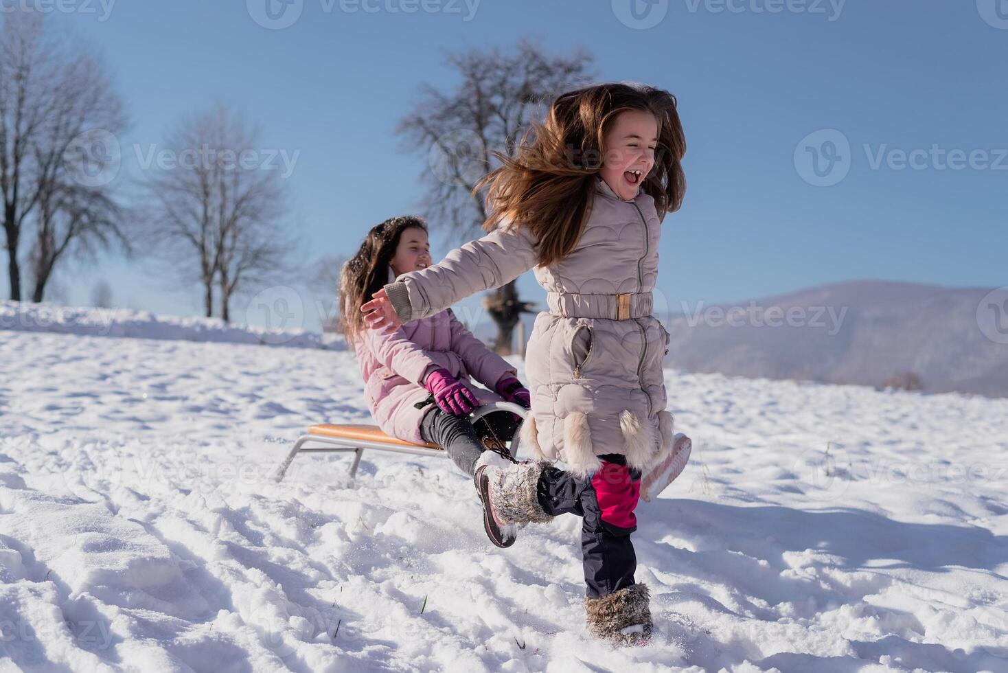 A happy children sled ride. Concept of a happy family winter holiday and playing in the snow. photo