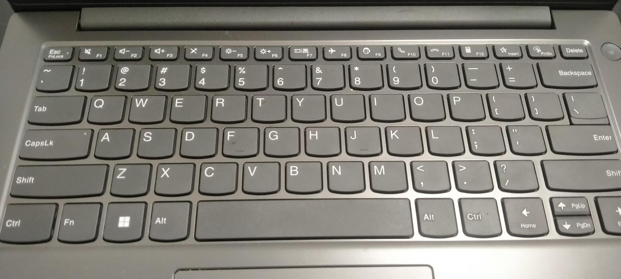 Details of the laptop keyboard photographed from various angles, showing a modern design with an ergonomic key layout photo