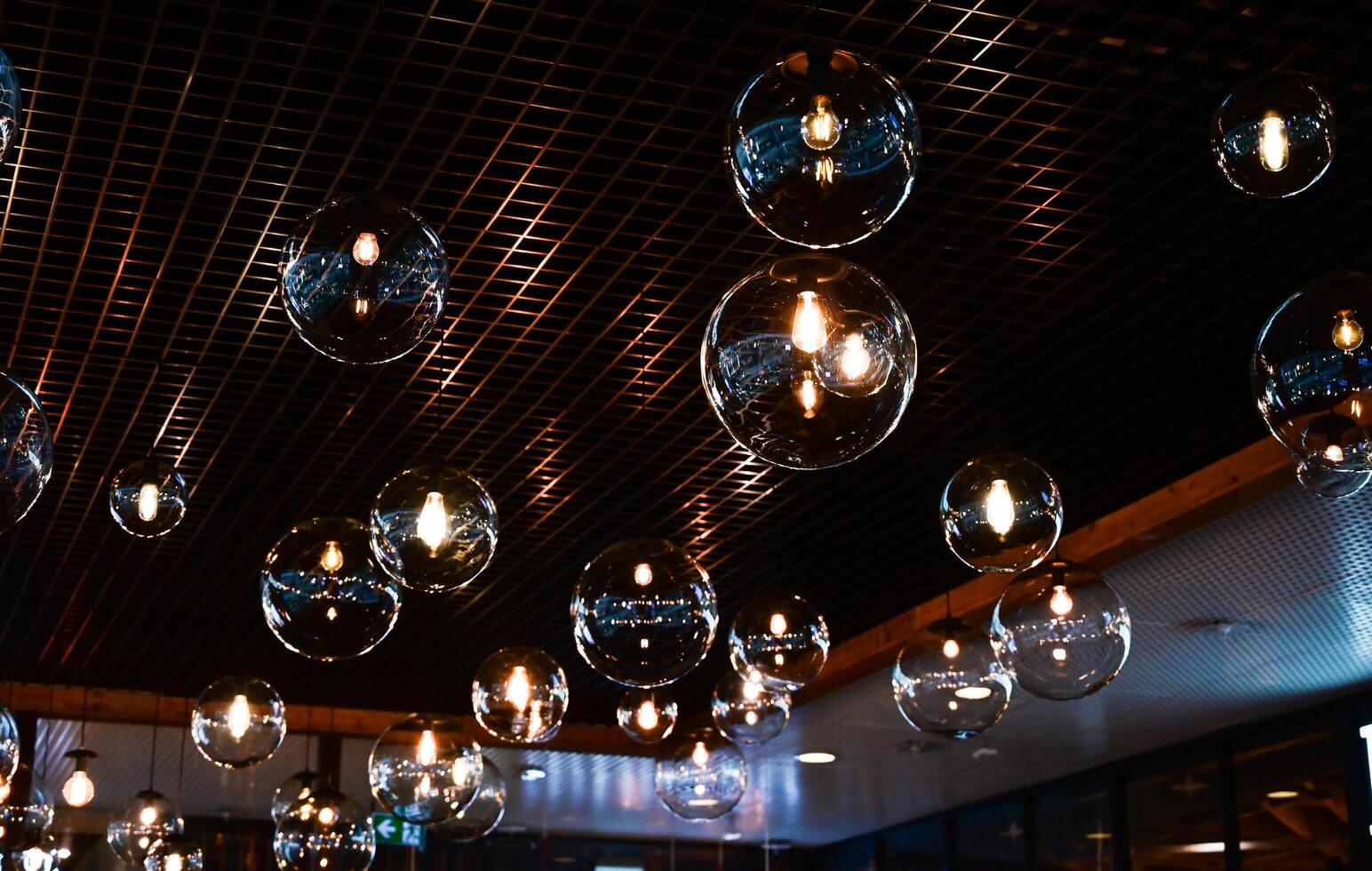 Round-shaped LED lamps on the ceiling in the interior of the restaurant photo