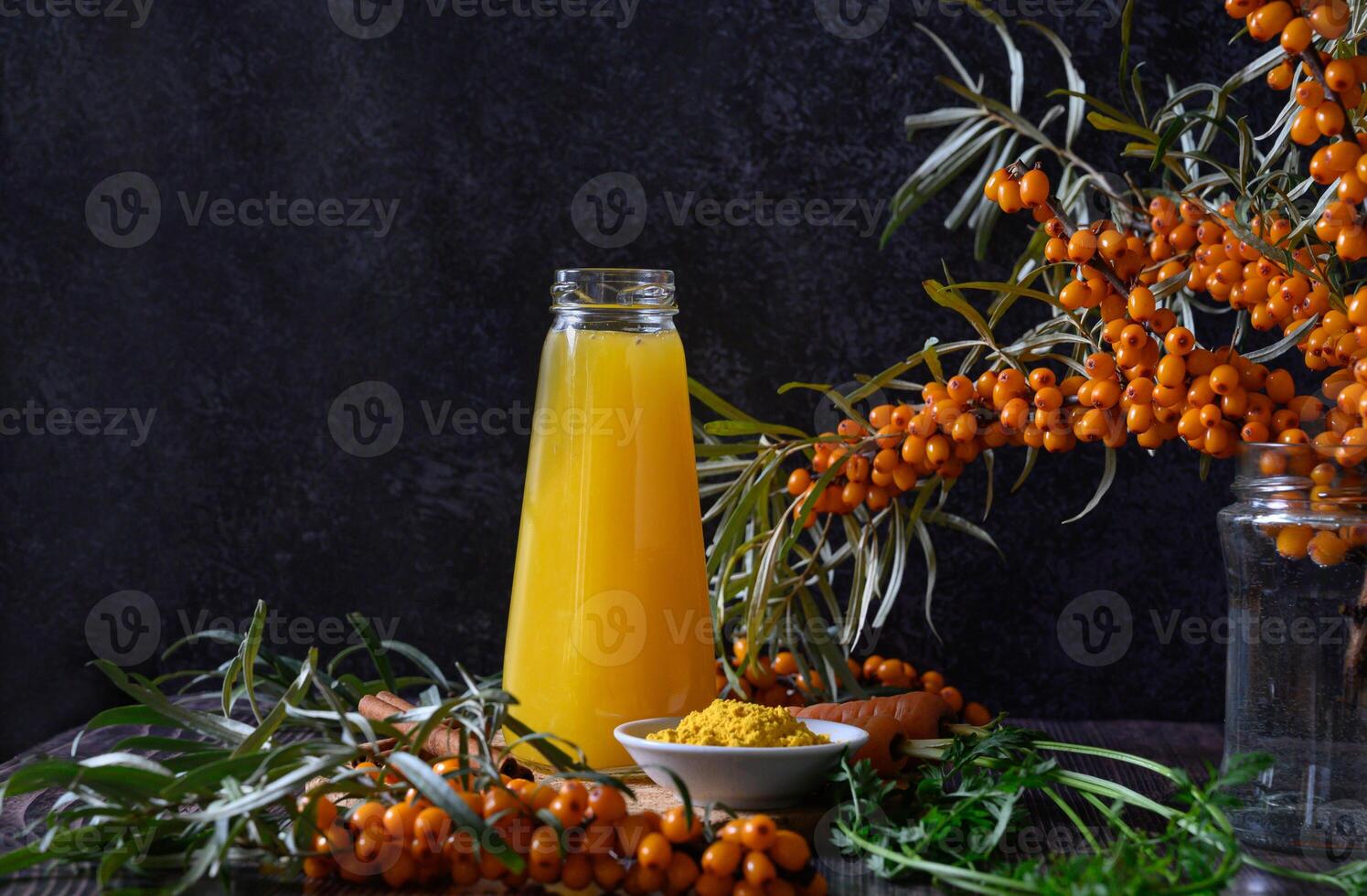 The bottle is placed on a wooden surface with a bowl of yellow powder in front of it. photo