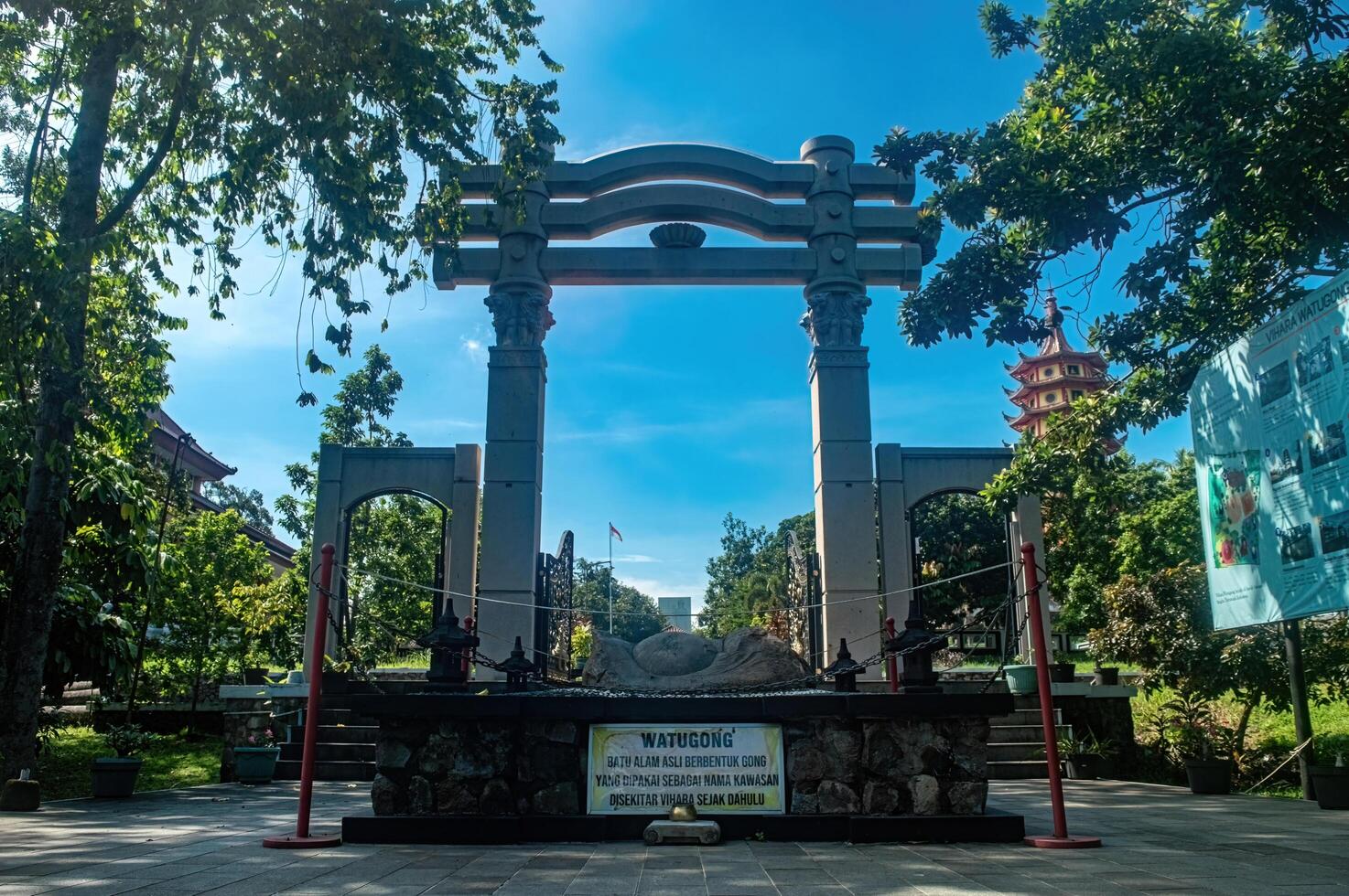 The serene Watu Gong Pagoda gate, surrounded by greenery and a clear sky, captures tranquility and heritage, often linked to Lunar or Chinese New Year. Indonesia, 17 November 2024 photo