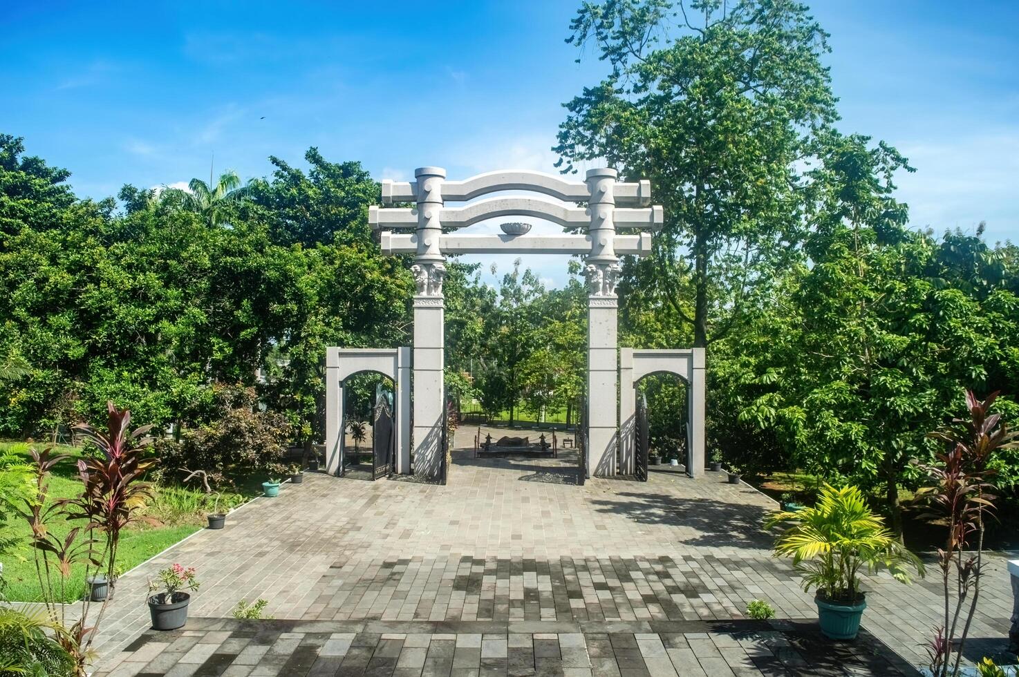 The serene Watu Gong Pagoda gate, surrounded by greenery and a clear sky, captures tranquility and heritage, often linked to Lunar or Chinese New Year. Indonesia, 17 November 2024 photo