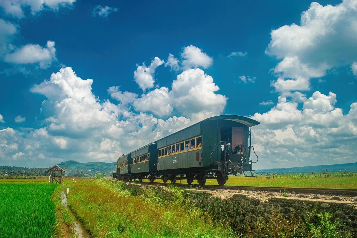 A historic tourist train travels through the scenic countryside of Ambarawa, showcasing the region's rich heritage and natural beauty. Indonesia, 17 November 2024 photo