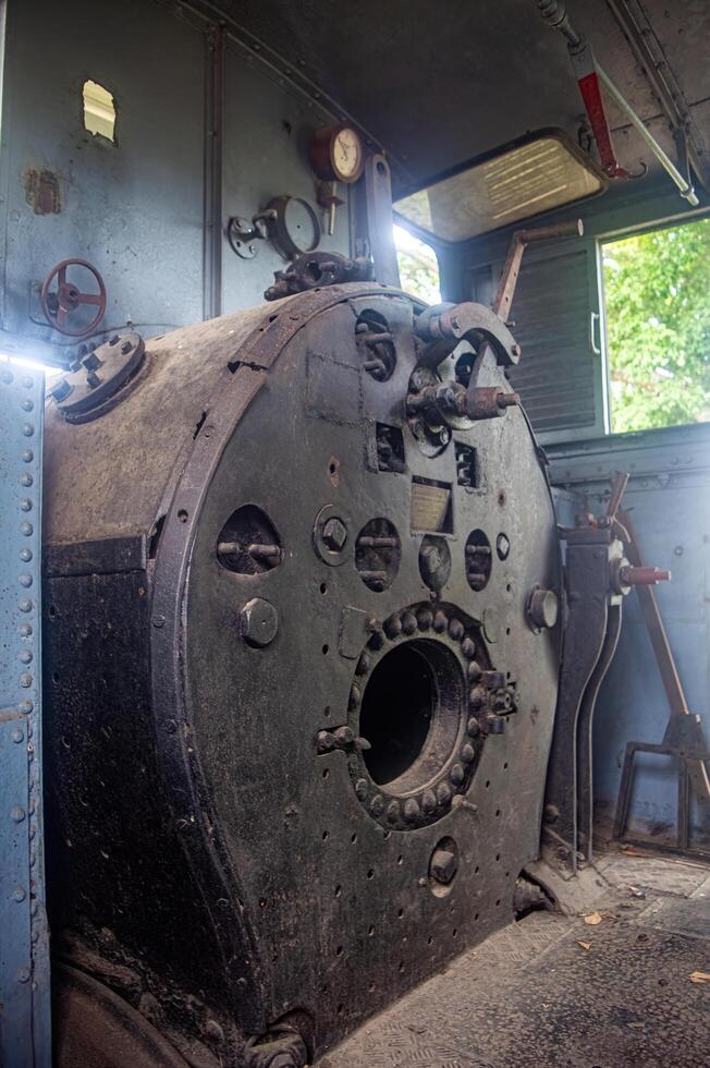 Interior view of a steam locomotive cabin at the Ambarawa Railway Museum, highlighting the intricate machinery and historical value, Indonesia, 17 November 2024 photo