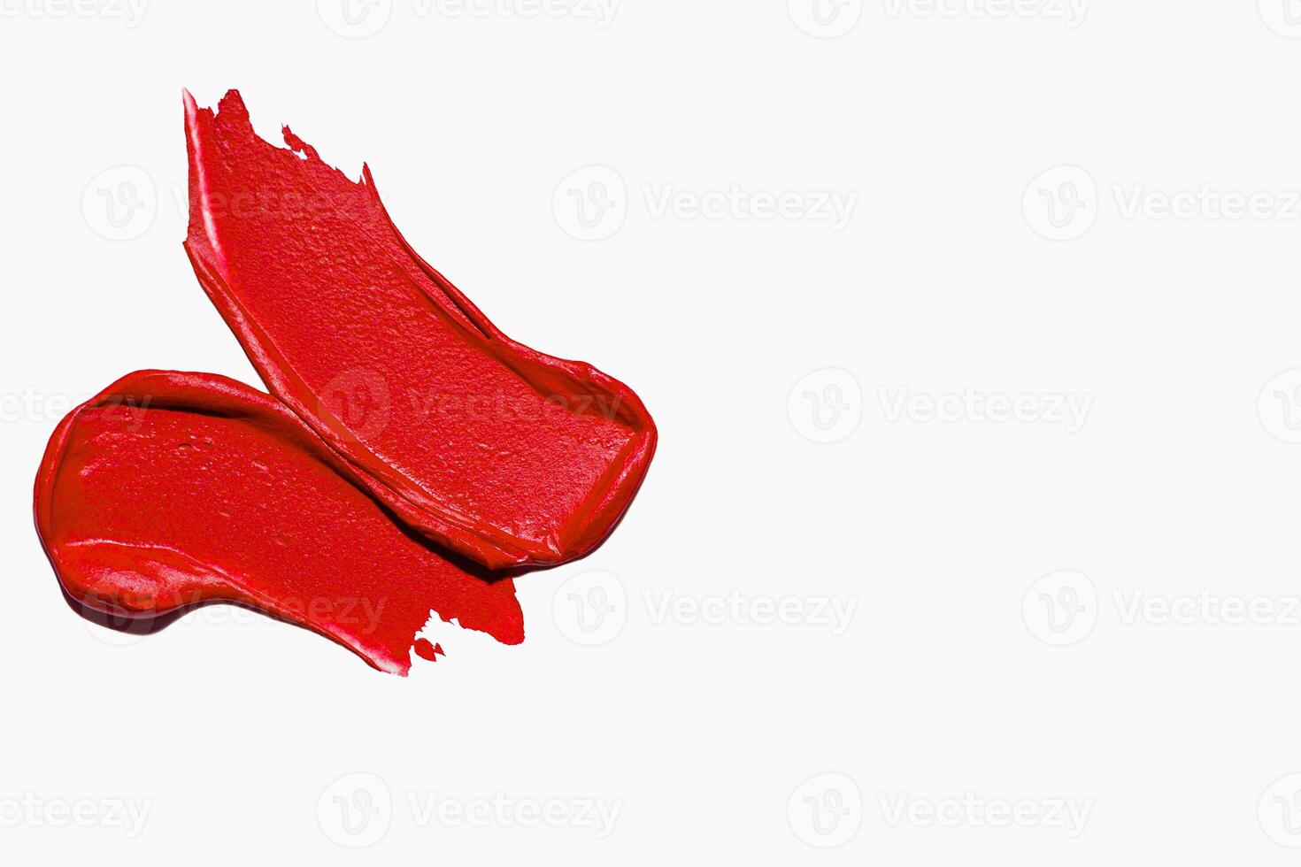 Colorful strokes of red matte lipstick on a light background with empty space photo