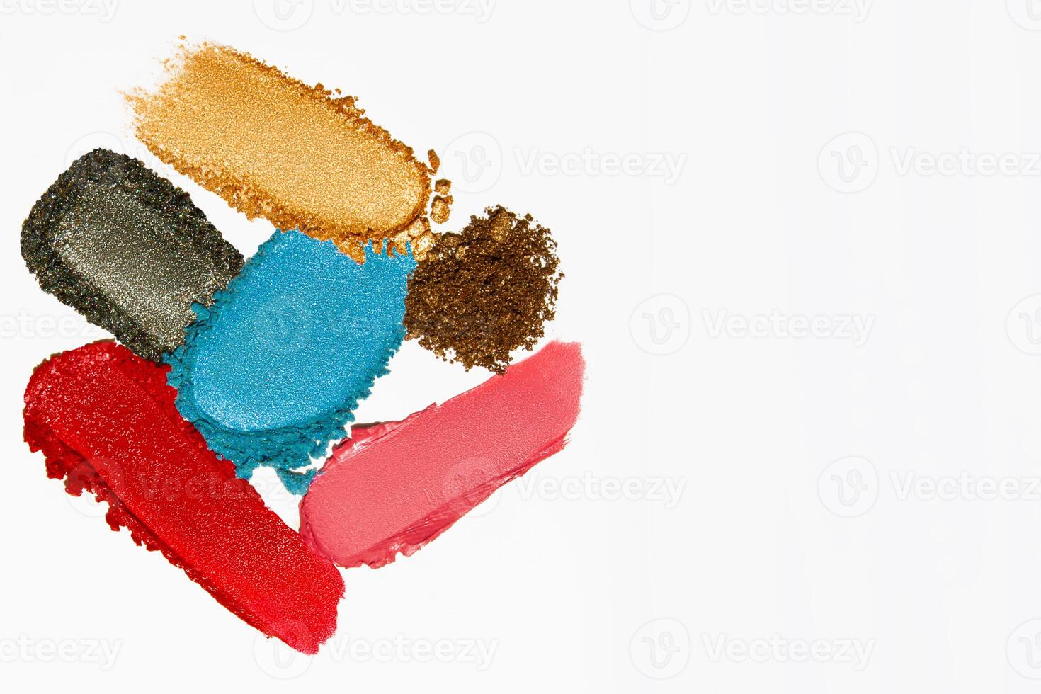 Cosmetic texture composition with vibrant lipstick, eyeshadow, bronzer, glitter, and powder with empty space on a light white background. photo
