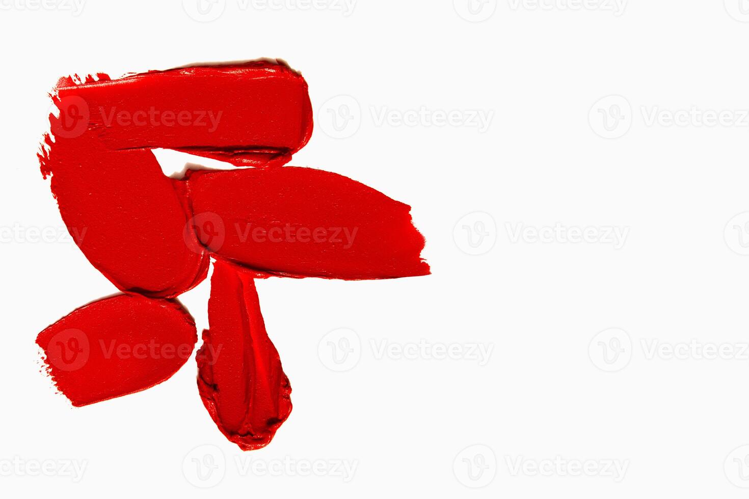 Matte lipstick smears and strokes in red tones with empty space on a light white background. Cosmetic product composition. photo