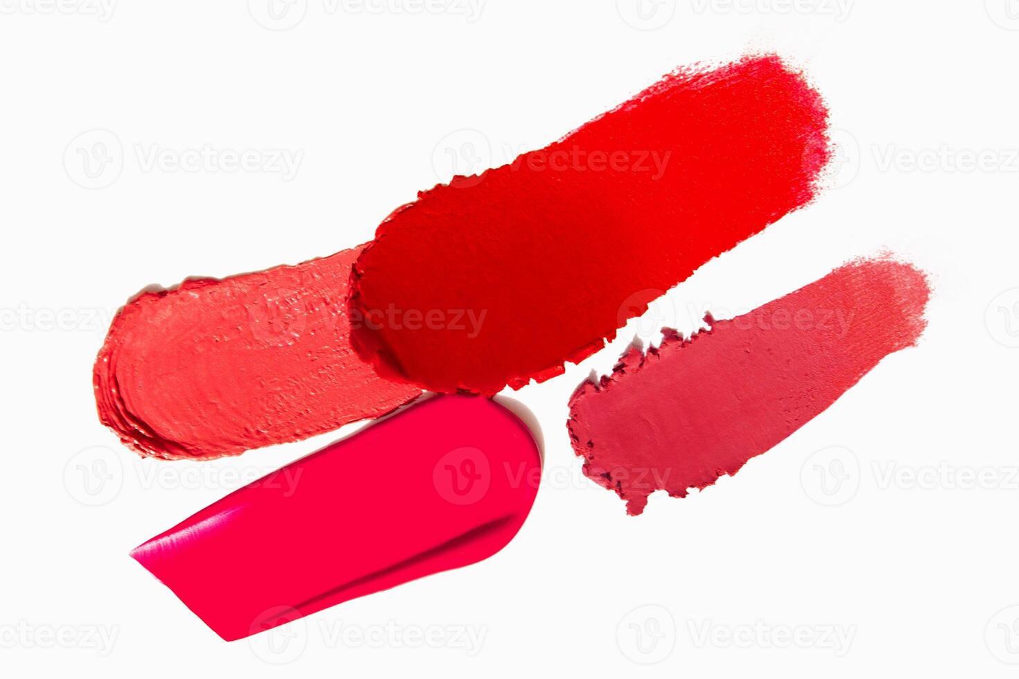 Range of red lipstick texture composition on a light white background. Cosmetic product smear smudge swatch sample. photo