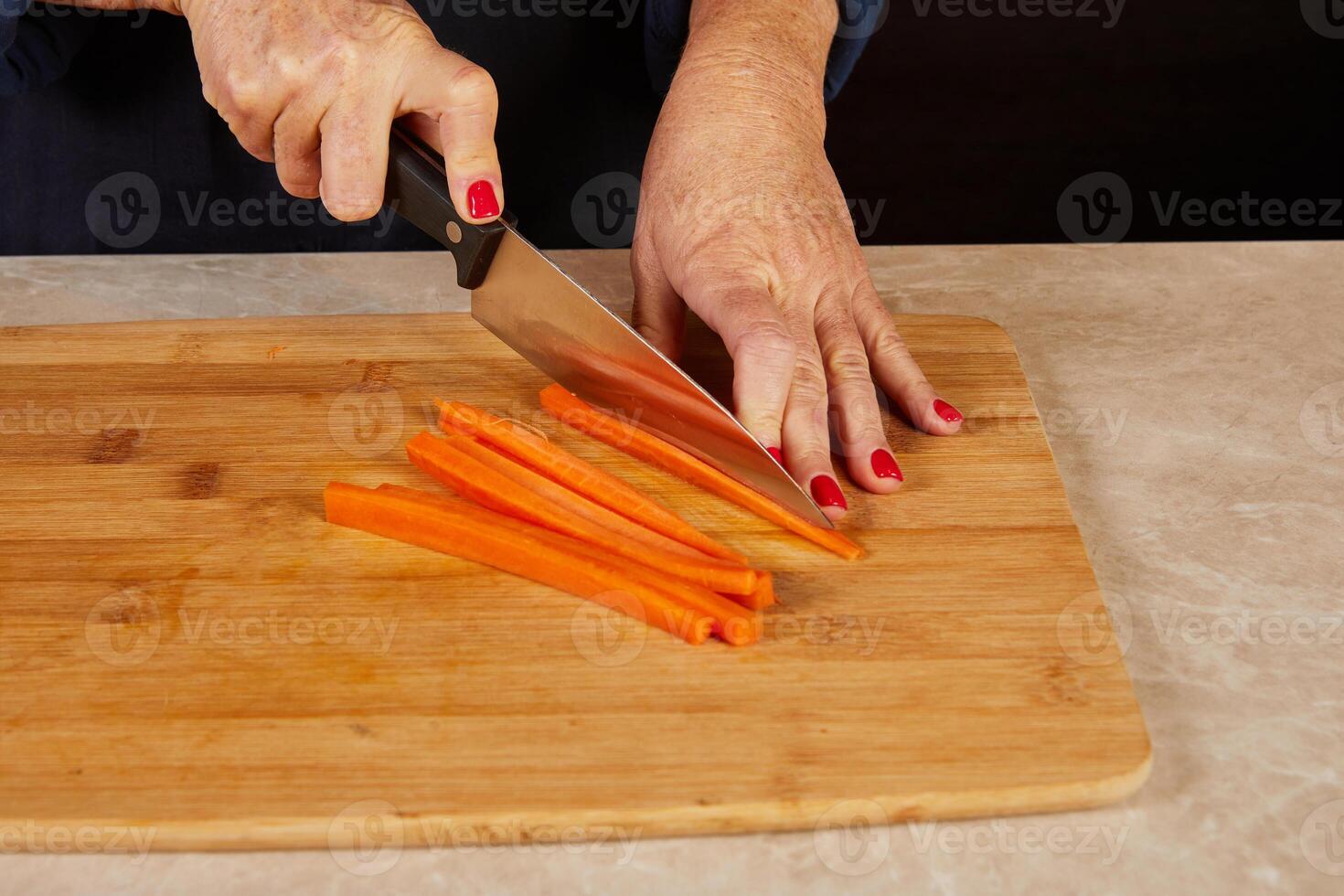 Slicing carrots into even sticks photo