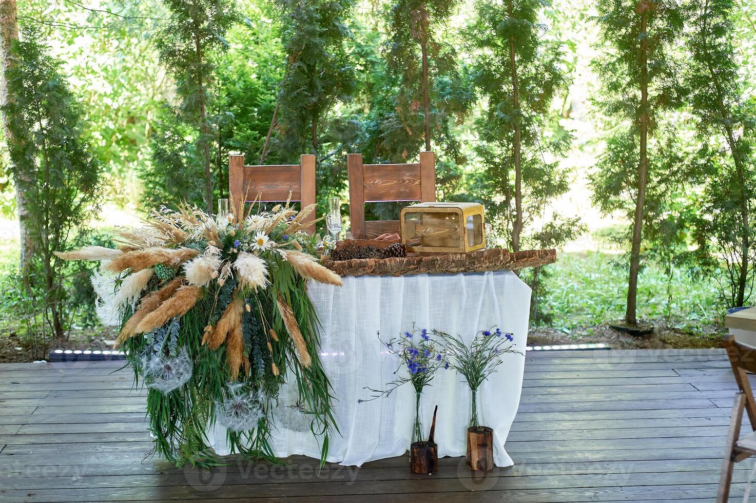 Wedding decoration. Floristics. Table decoration in white and brown. Pampas, dried flowers, cones. photo