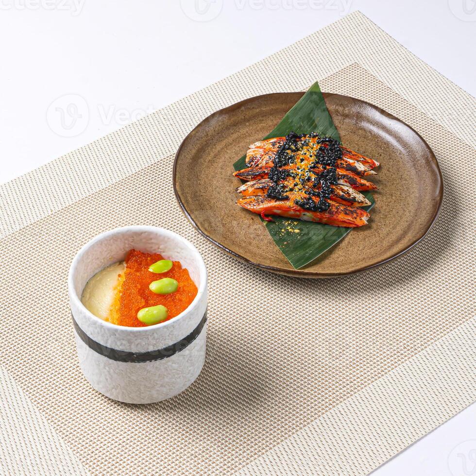 KING CRAB CHAWANMUSHI with ikura, salmon roe and edamame served in plate isolated on napkin side view of Japanese food on white background photo