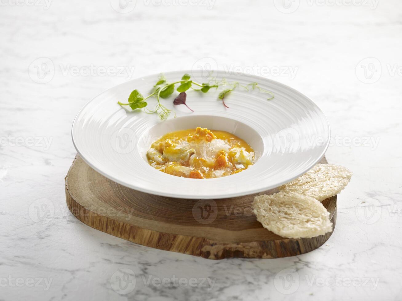 Braised Supreme Birds Nest with Crab Roe served in a dish on wooden board side view on grey marble background photo