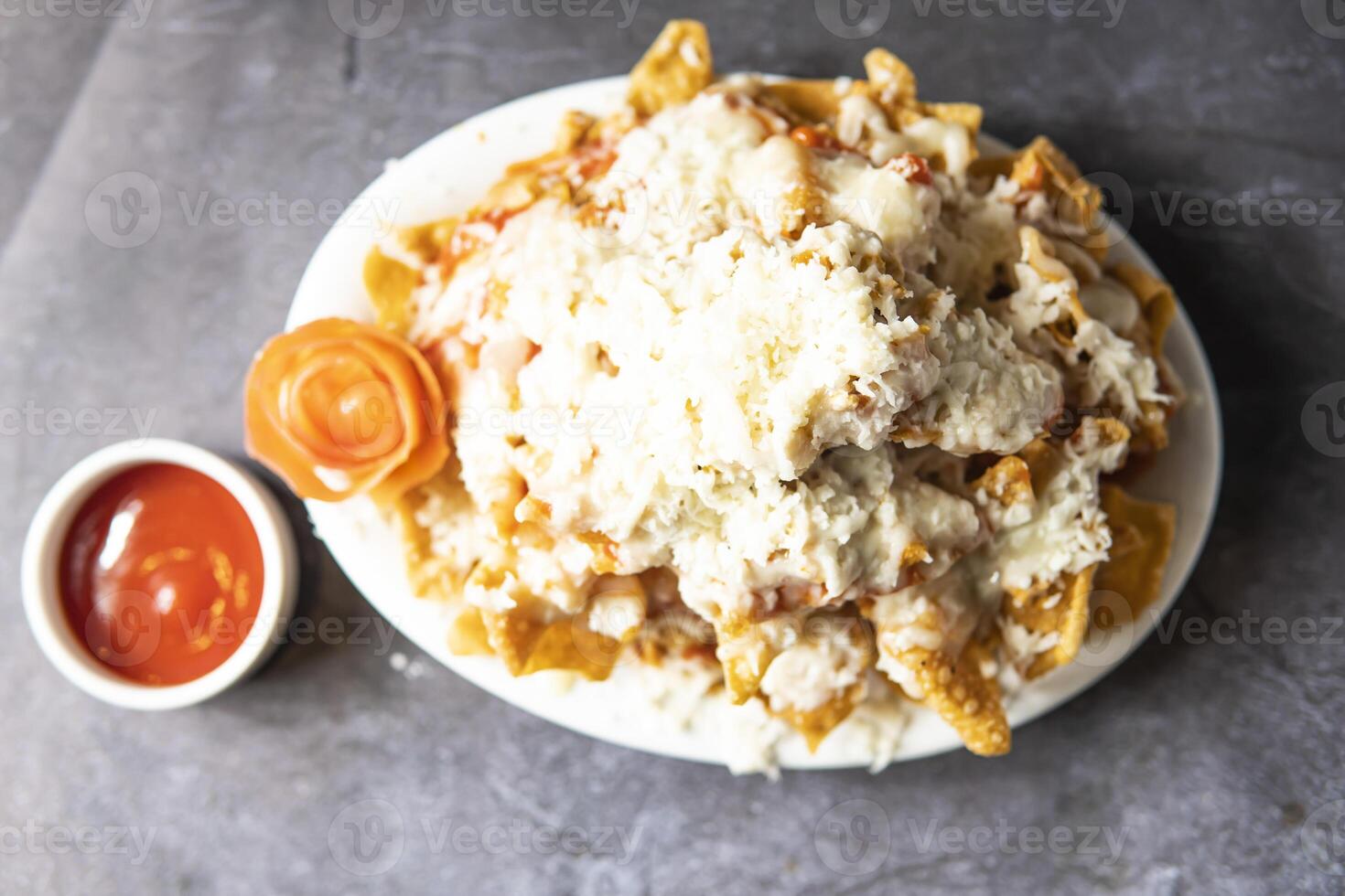 Chicken Nachos with ketchup served in tray dish isolate on grey background top view of indian, bangladeshi and pakistani food photo