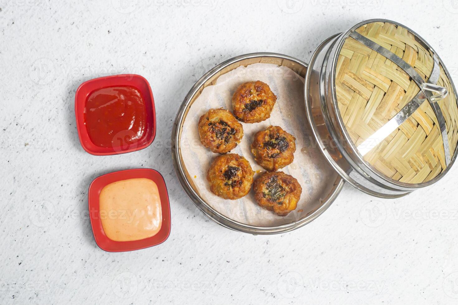 Fried Chicken with Lemon Grass Shumai with mayo dip and tomato sauce served in bamboo steamer isolated on white background top view of bangladeshi, indian and chinese dim sum food photo