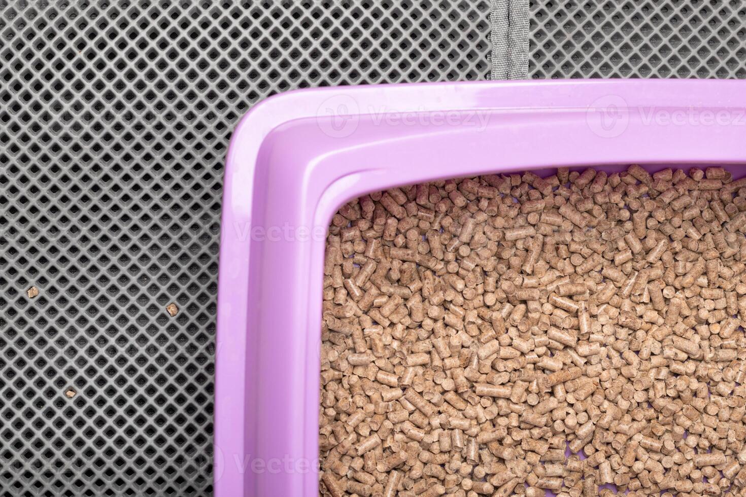 A cat tray for a toilet with wood ecological filler on a waterproof mat. Nobody. Mat absorbing photo