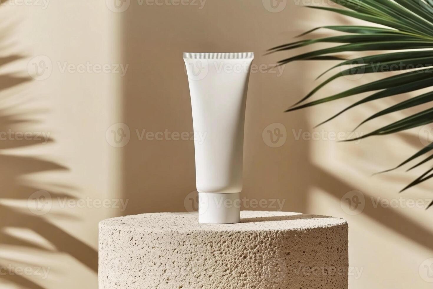 Mockup of cosmetic tube cream 50ml on stone stand on beige background minimalist with green leaves palm. Natural hard lighting and shadows photo