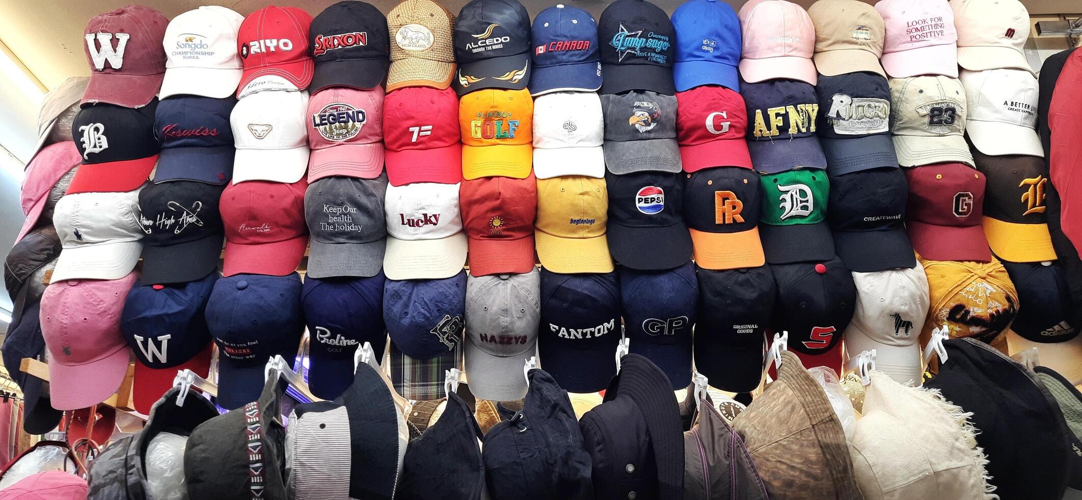 Variety of thrift hats on the display for sale at Pasar Senen. Jakarta, Indonesia - December 11 2024 photo