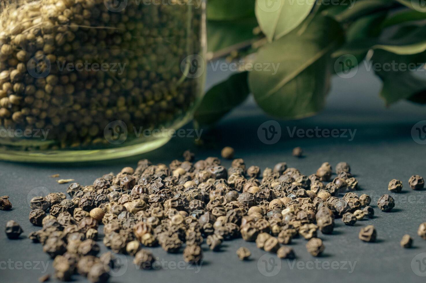 various spices scattered on a dark background with bunches of grass, laurel leaves, berries and other spices for cooking fragrant Eastern and Midwestern food. High quality photo