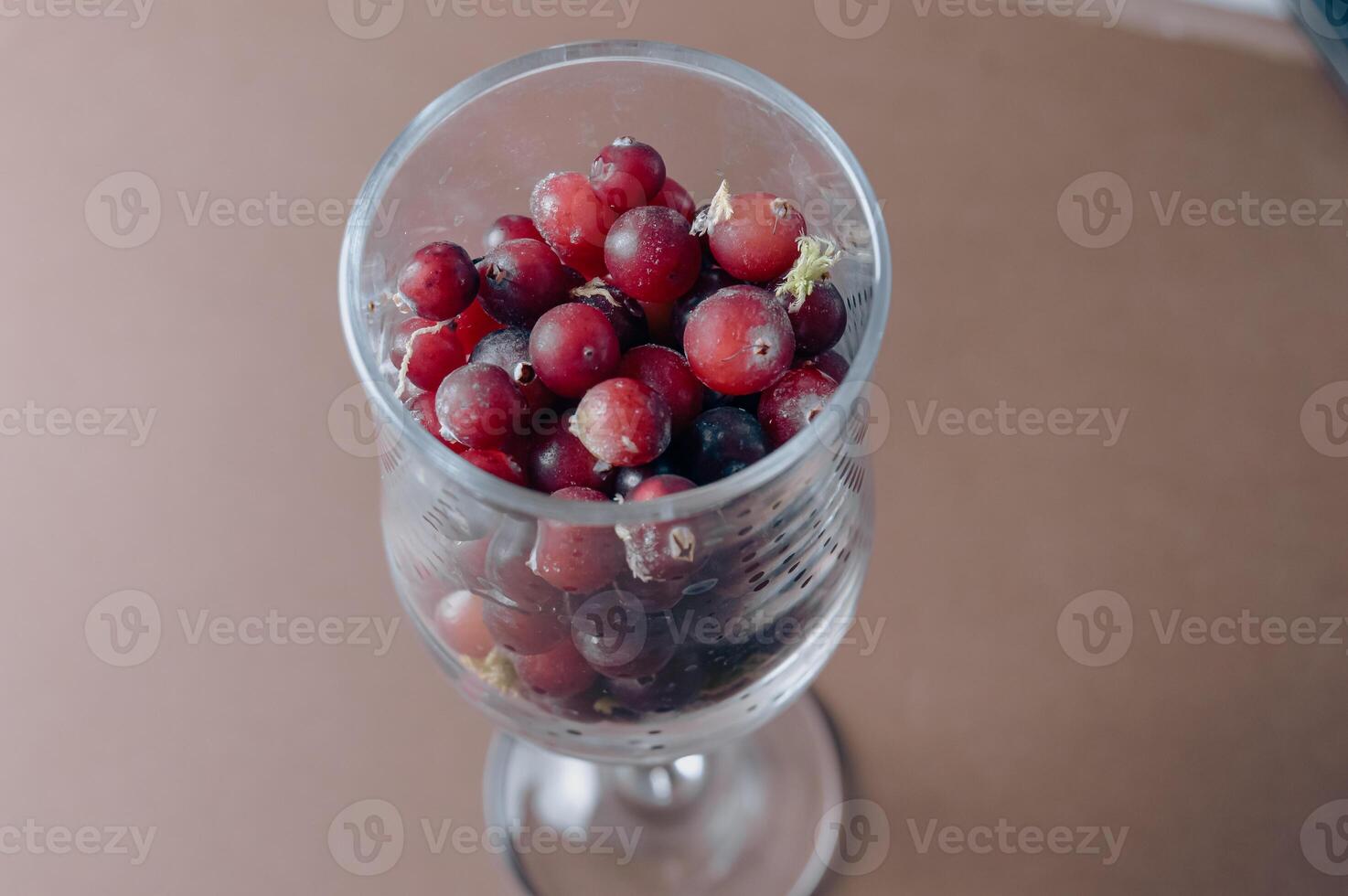 frozen red cranberry berry in a wine glass. High quality photo