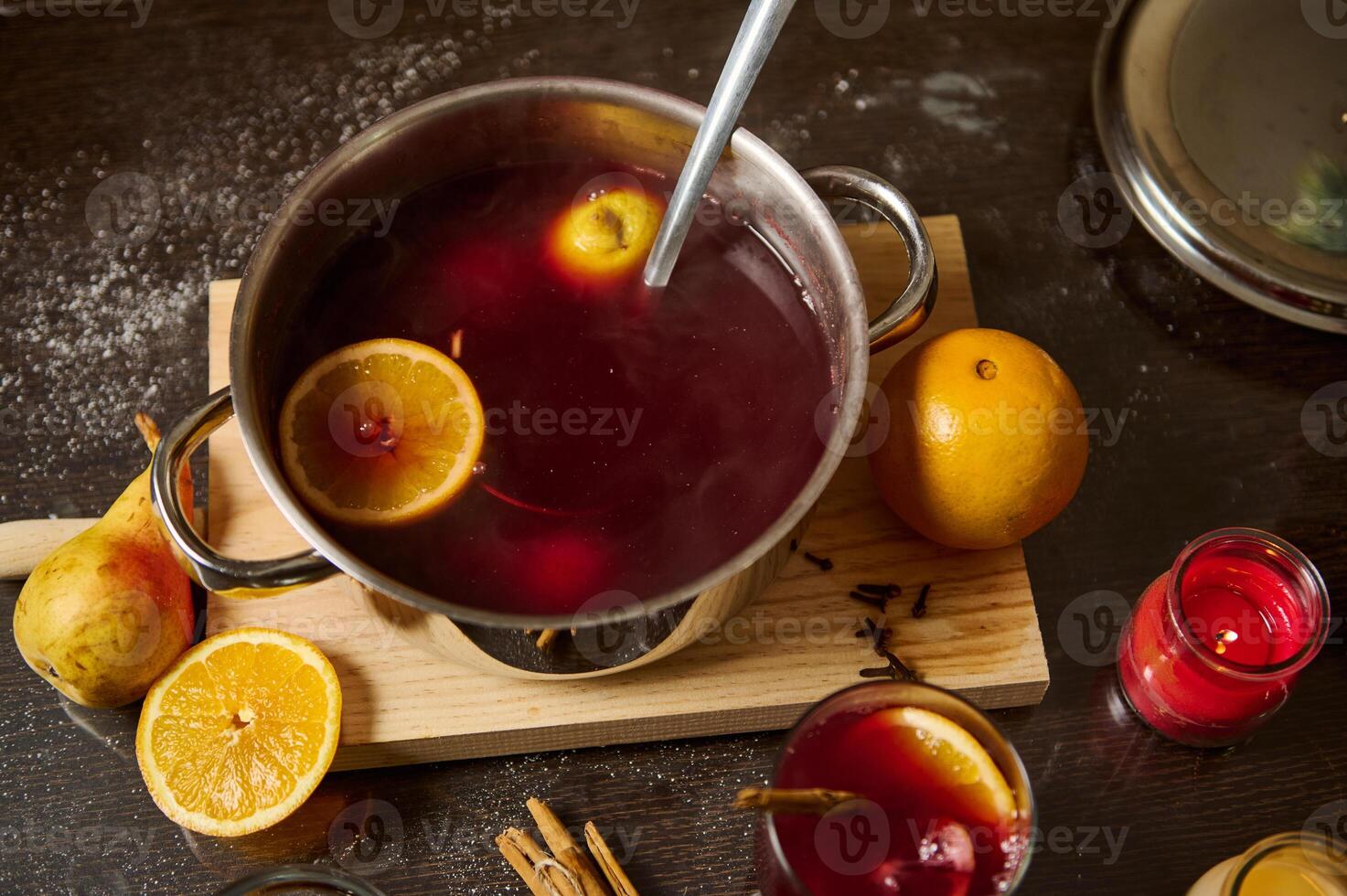 Warm mulled wine with oranges and spices for festive gatherings photo