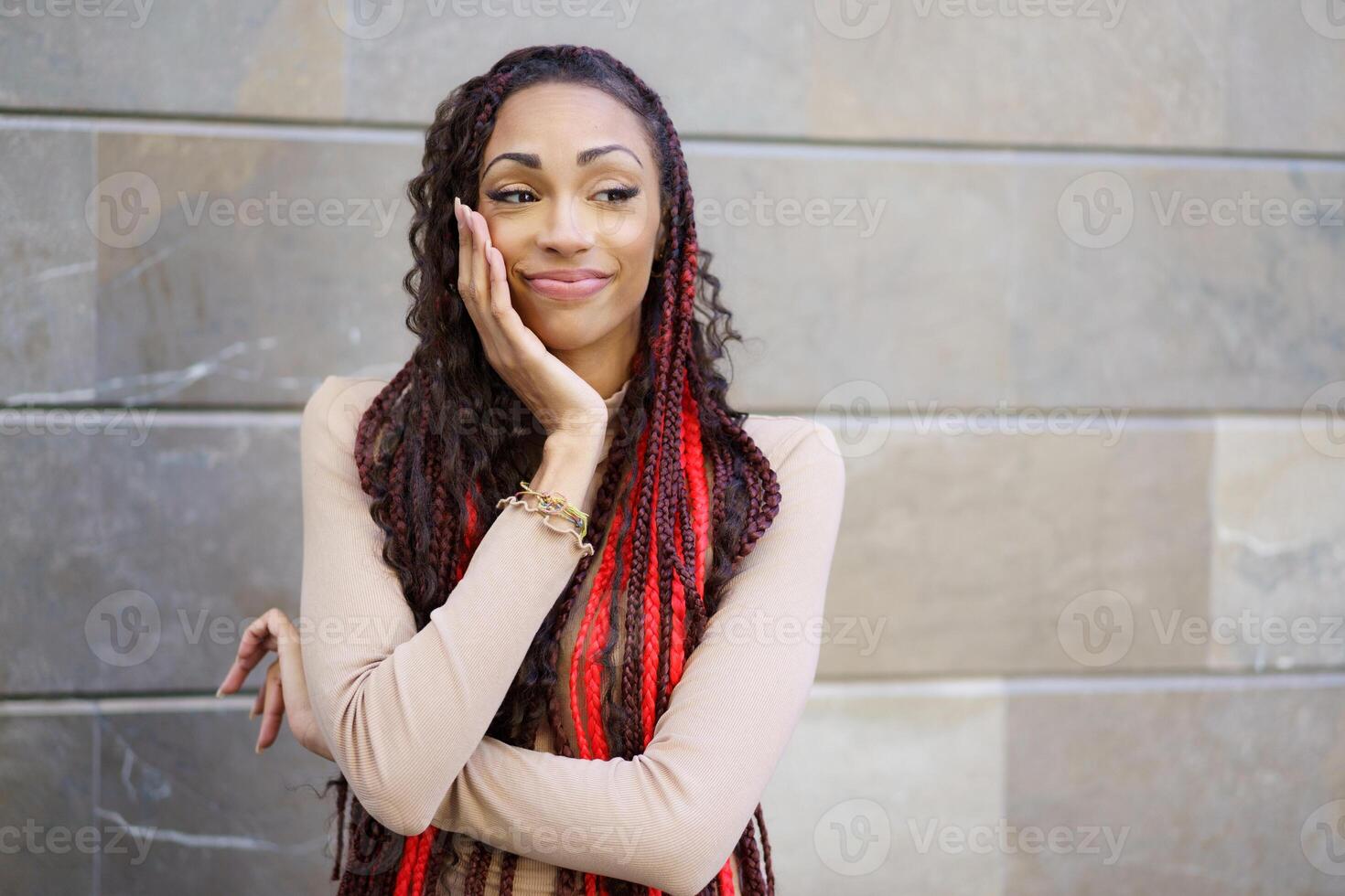 A Stylish Woman is Posing with Unwavering Confidence in a Vibrant Urban Setting Environment photo