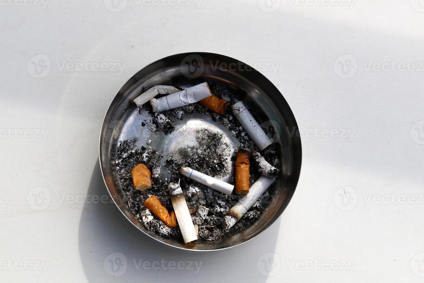 cigarette butts in an ashtray photo